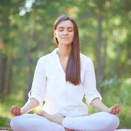 a woman practicing kapalbhati