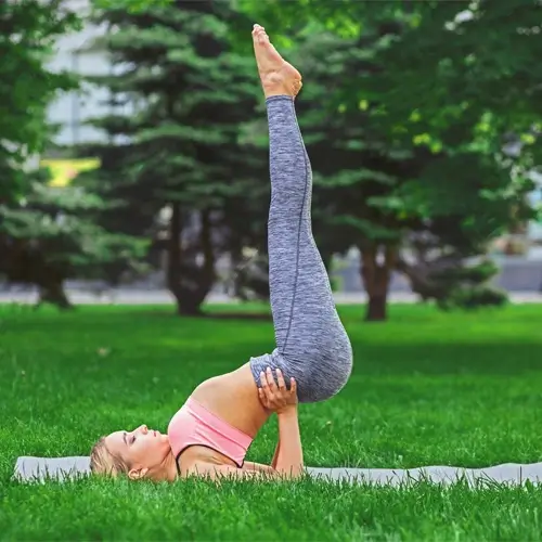 a woman practicing sarvangasana for weight loss